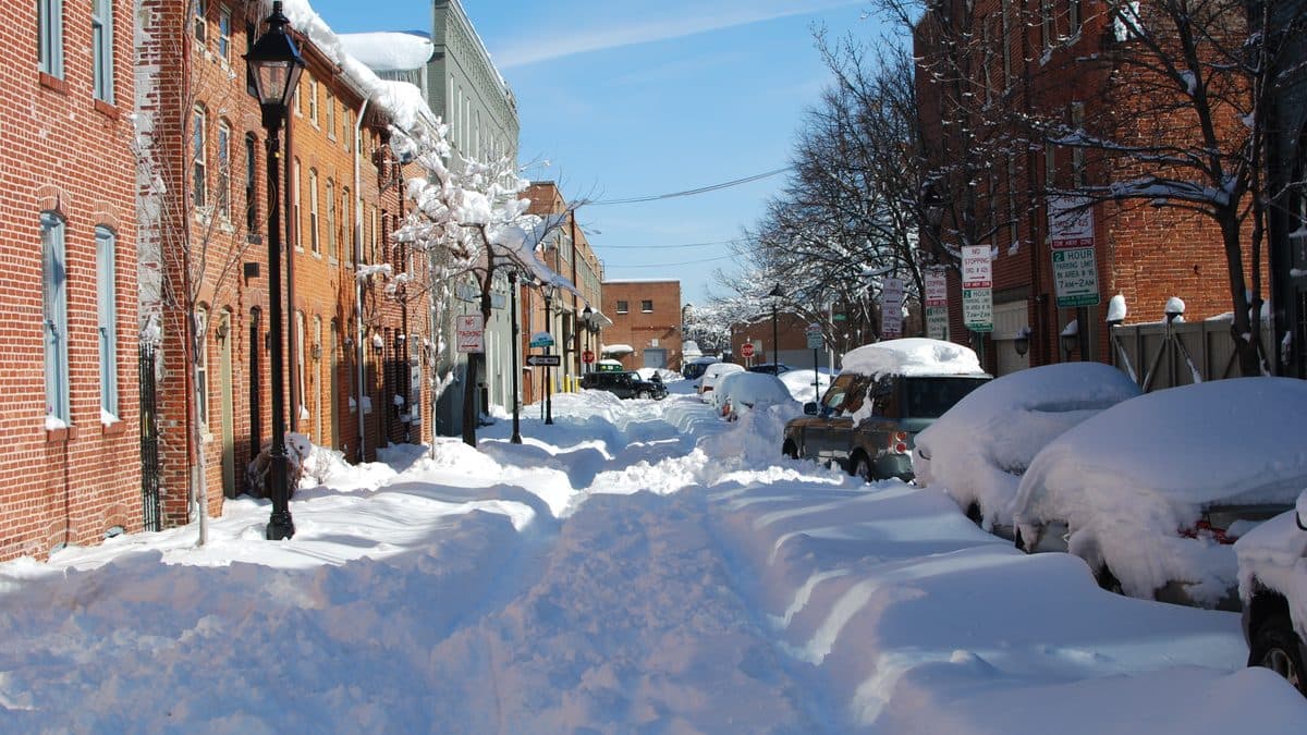 Baltimore rowhouses on Lancaster Street in Fells Point buried in deep snow under a blue sky after the February 2010 blizzard