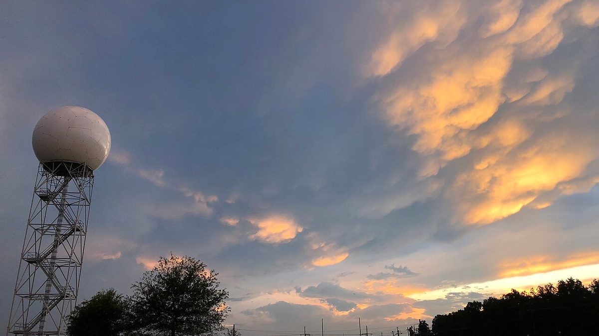 A WSR-88D NEXRAD weather radar tower under mammatus clouds at sunset near Sterling, Virginia, the kind of radar network that feeds snowfall forecasts