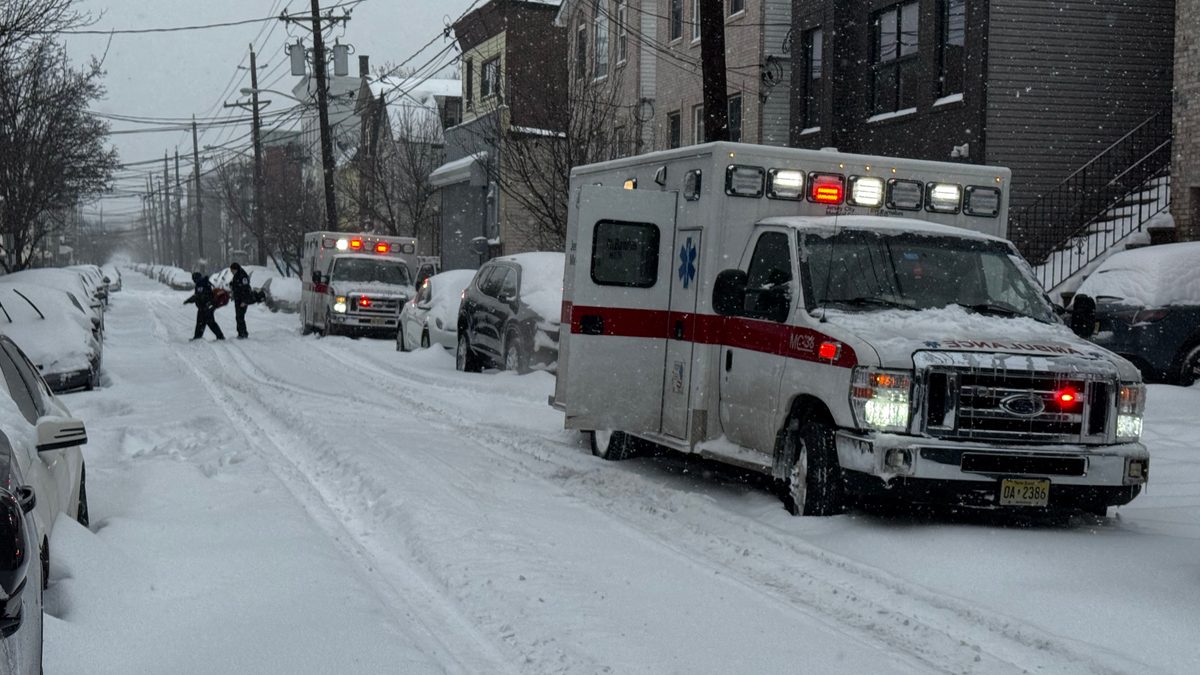 An ambulance drives through heavy snow during Winter Storm Fern in Jersey City, New Jersey