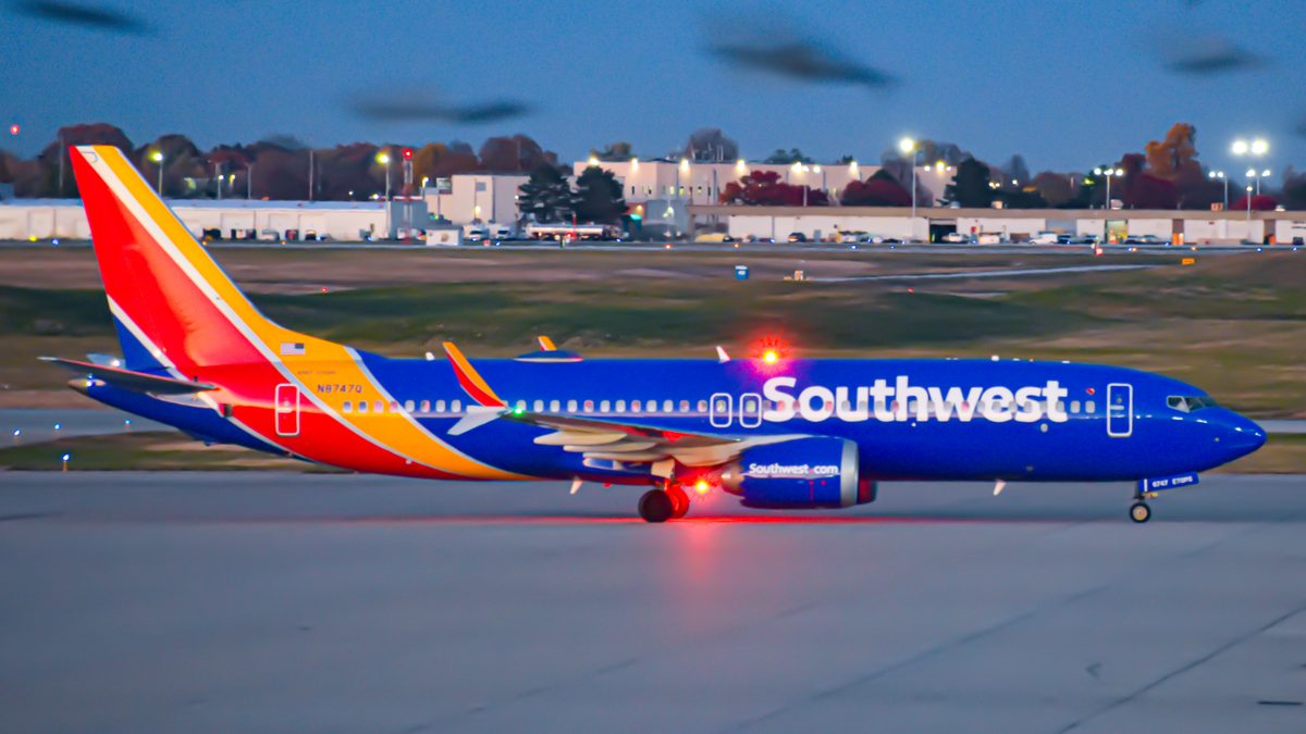 A Southwest Airlines Boeing 737 MAX 8 taxiing to its gate at Indianapolis International Airport at dusk