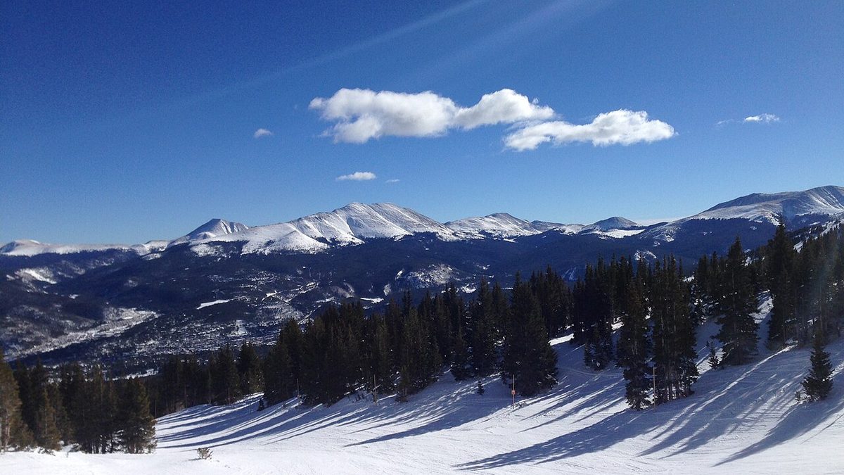 Snow-covered Rocky Mountain peaks near Breckenridge, Colorado, seen from a ski slope on a clear winter day